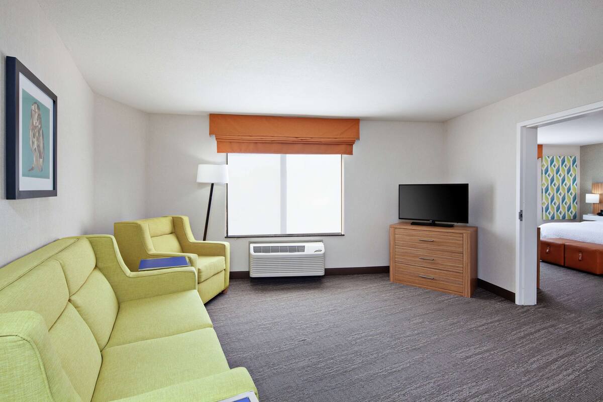 Business Suite, 1 King Bed, Non Smoking | Living area | 42-inch flat-screen TV with cable channels, TV, pay movies