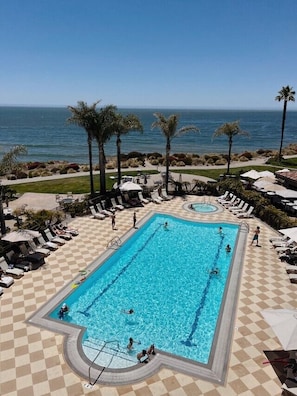 Een buitenzwembad, parasols voor strand/zwembad