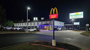 A McDonald's and Budgettel Inn & Suites hotel at night.