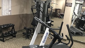 A gym with treadmills, dumbbells, and exercise machines. - Argyll Plaza Hotel (Edmonton)