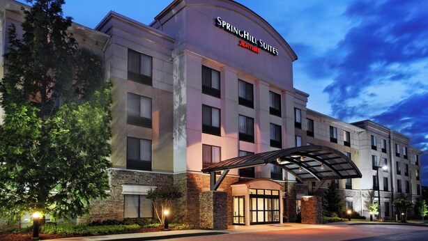 A hotel with a modern design, featuring a prominent entrance with a covered walkway and a large sign displaying the name 'Springhill Suites'. - SpringHill Suites by Marriott Knoxville at Turkey Creek (Knoxville)