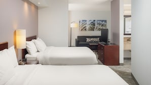 A hotel room with two beds, a desk, a chair, a lamp, a painting, and a bathroom visible through an open door. - SpringHill Suites by Marriott Knoxville at Turkey Creek (Knoxville)