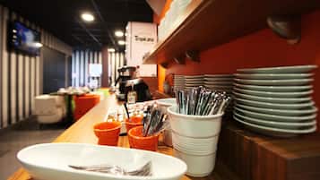 A buffet setup with various dishes and utensils.