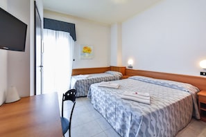A hotel room with two beds, a desk, a chair, a TV, and a painting on the wall. - Sunset (Rimini)