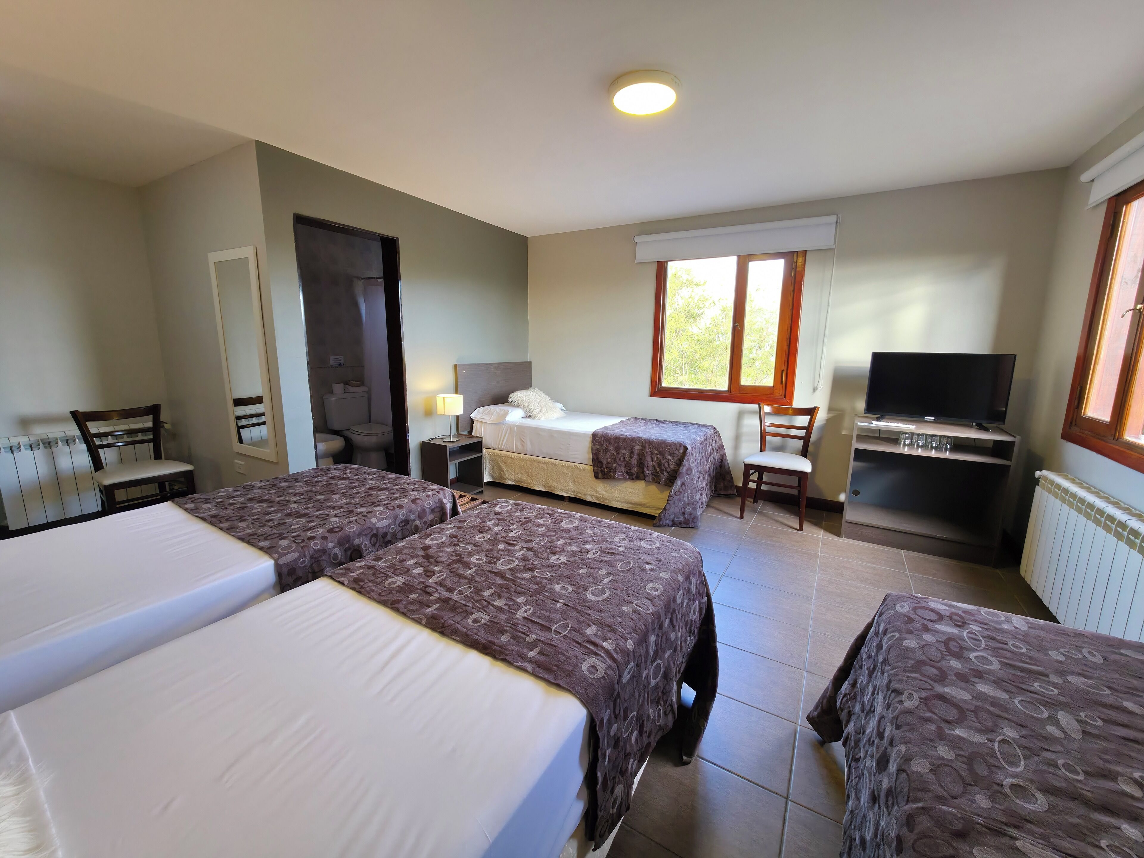 standard quadruple room | minibar, in-room safe, desk, iron/ironing board