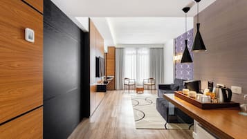 A modern kitchen with wooden cabinets, a dining area with chairs, and a kitchen island with a tray of breakfast items.