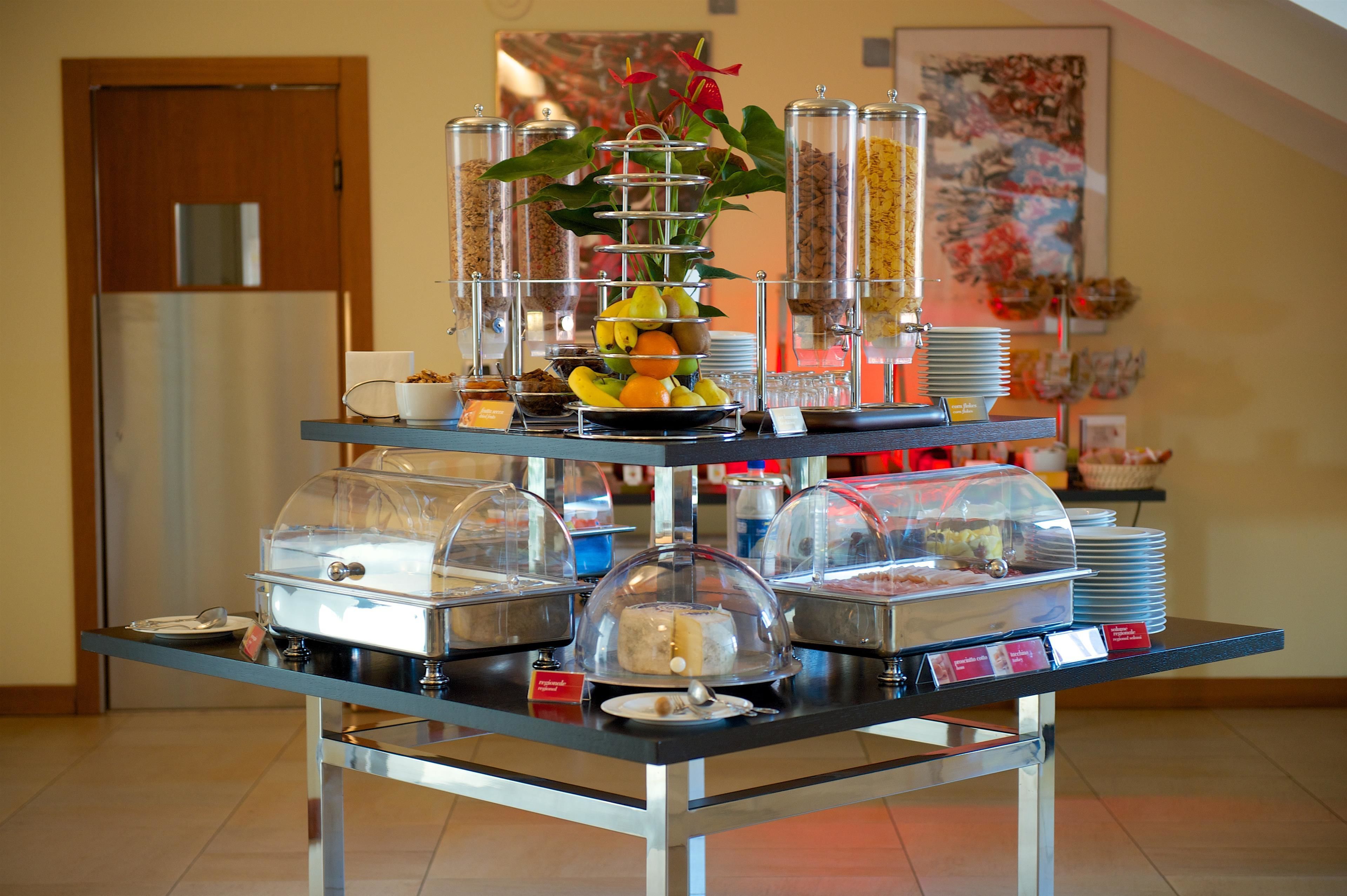 A buffet setup with various food items and condiments.