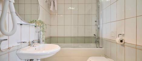 A bathroom with a sink, toilet, and bathtub.