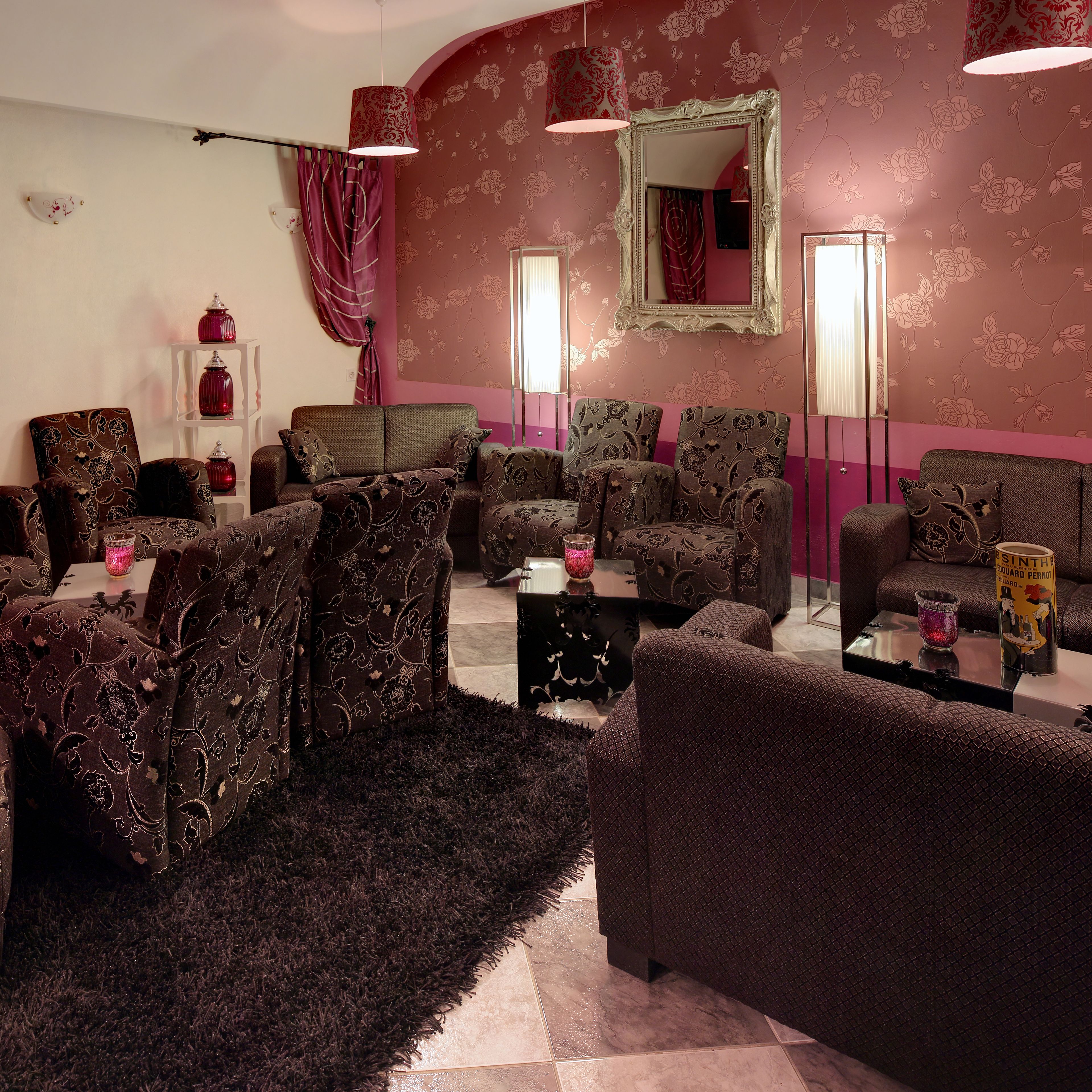 A living room with a sofa set, a coffee table, and a mirror.