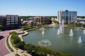 A large building with a central courtyard featuring multiple fountains and a circular walkway. - Newport News Marriott at City Center (Newport News)