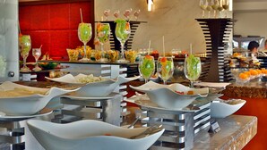 A buffet setup with various dishes and drinks.