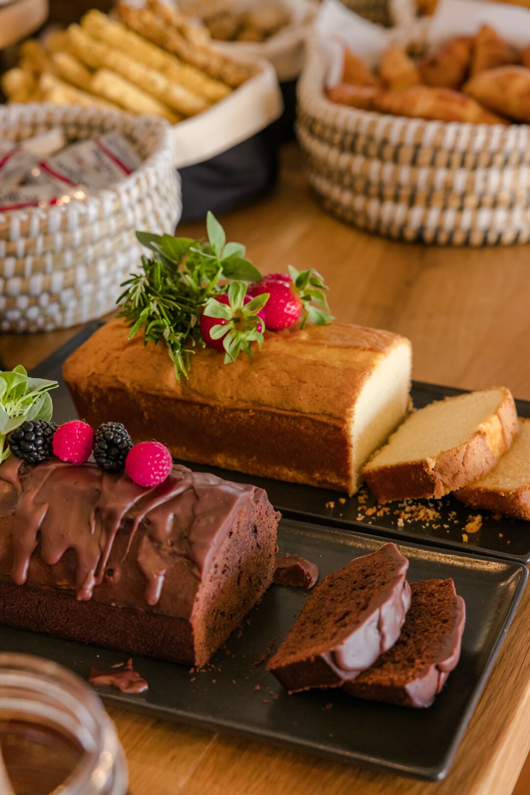 A chocolate-covered cake with berries on a plate.