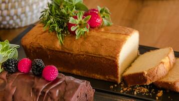 A chocolate-covered cake with berries on a plate.