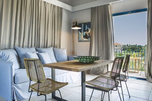 Junior Suite | Living room | 40-inch flat-screen TV with satellite channels, TV - Avithos Resort Apartments Hotel (Kefalonia)