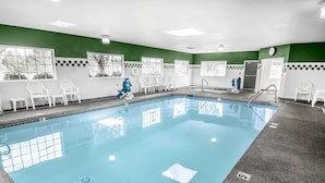 A swimming pool with a tiled deck, white chairs, and a clock on the wall. - Comfort Inn & Suites Salem Northeast (Salem)