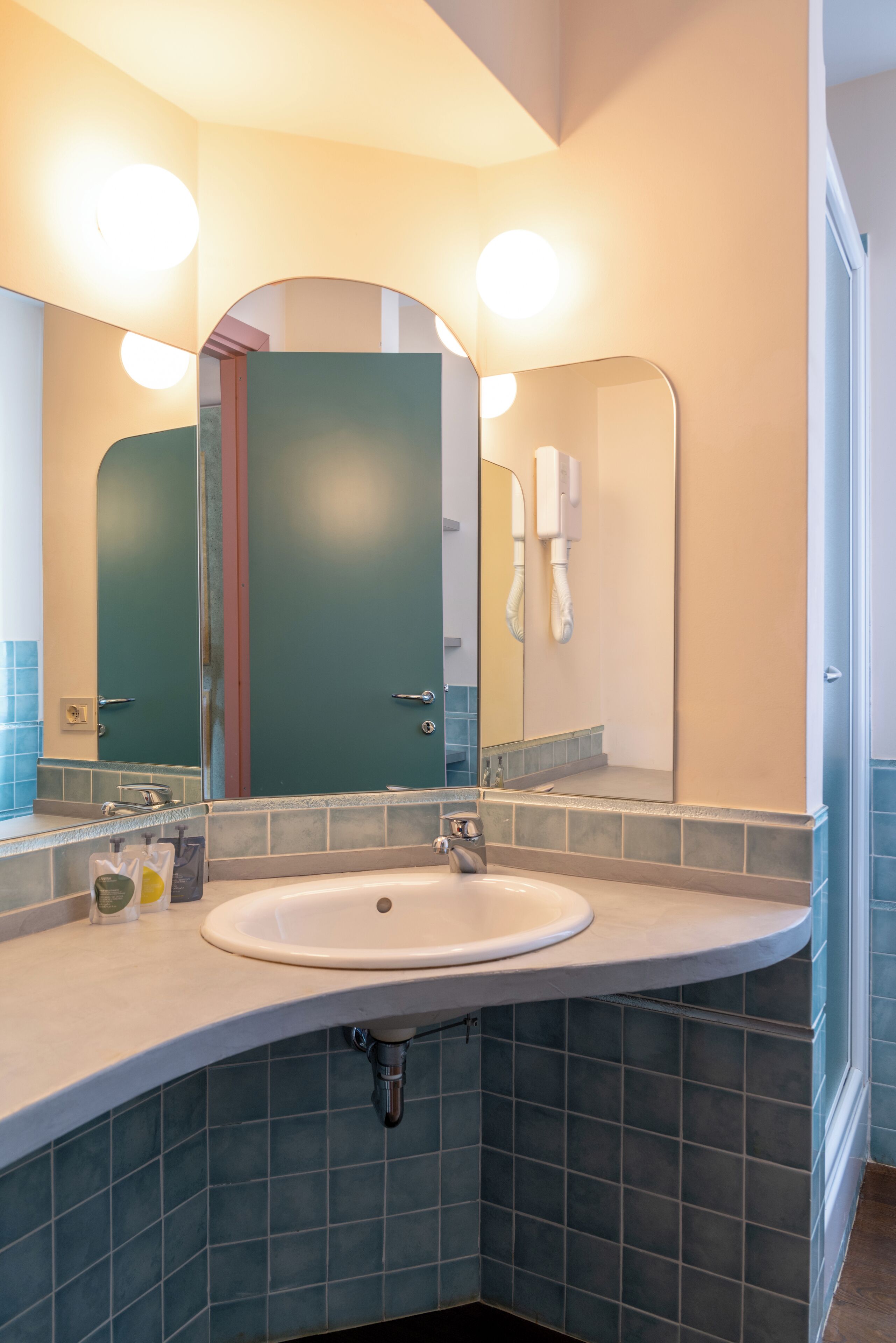 A bathroom with a sink, mirror, and towel rack.