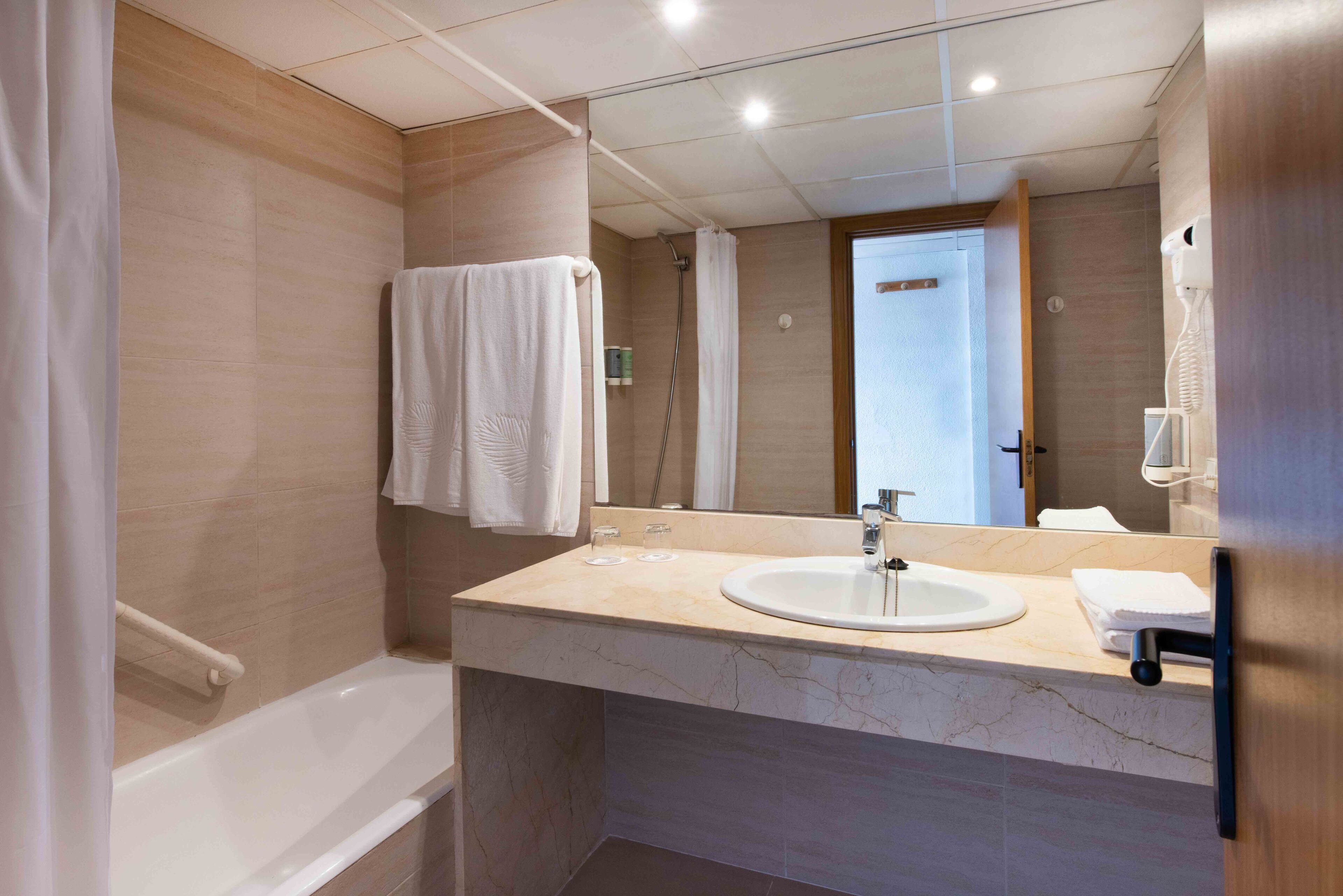 deep-soaking bathtub, eco-friendly toiletries, hair dryer, towels