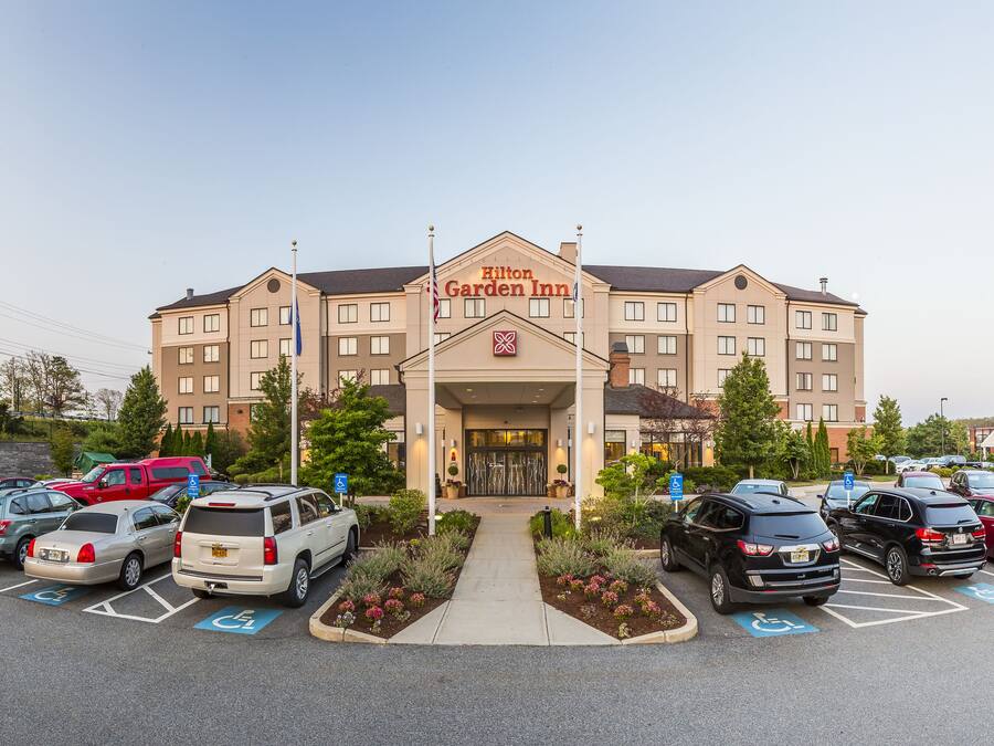 A Hilton Garden Inn with a parking lot in front.