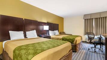 A hotel room with two beds, a desk, a chair, and a large window with curtains.