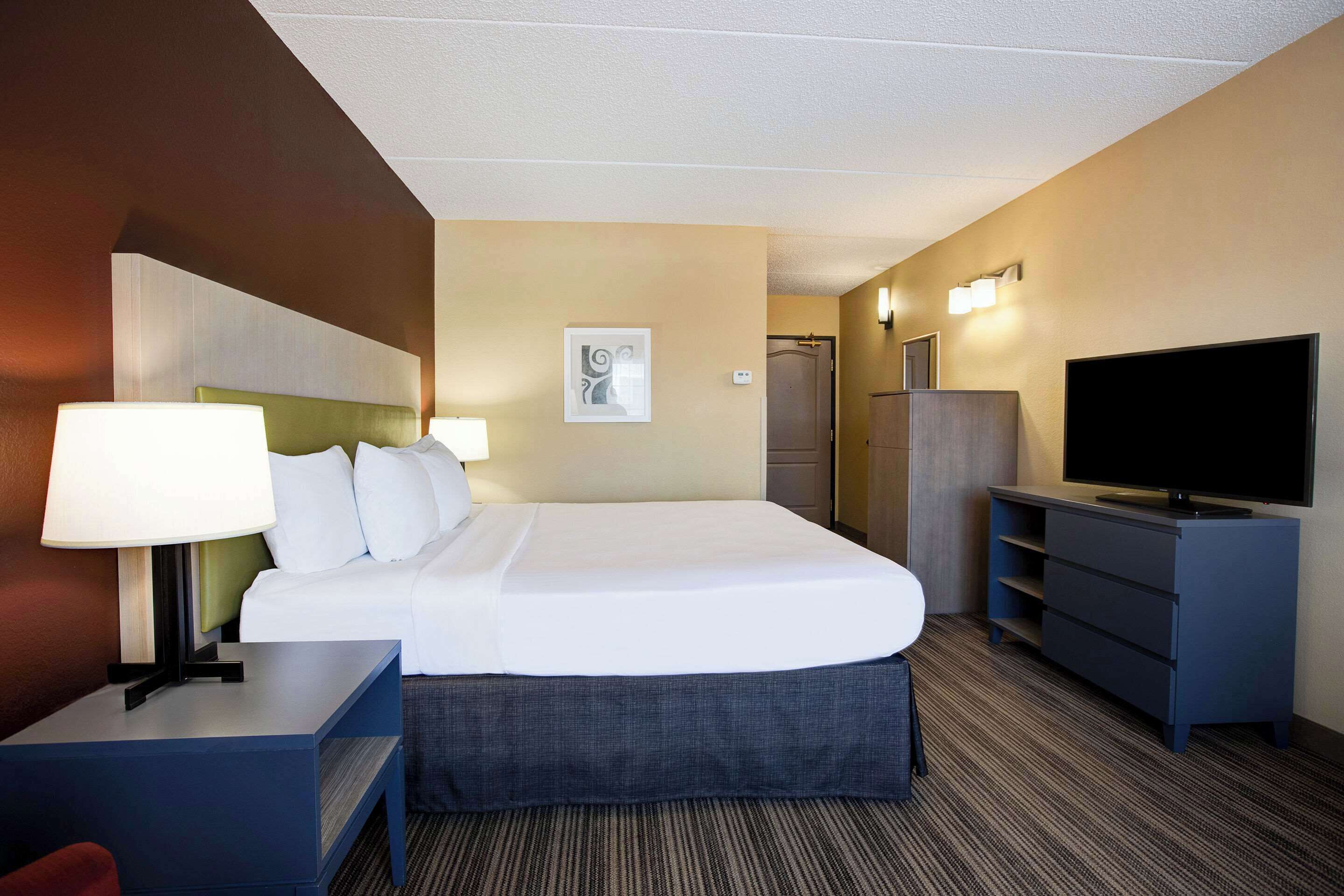 premium bedding, desk, laptop workspace, blackout curtains