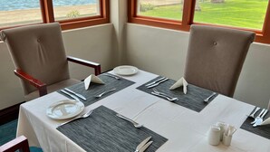 A dining table set for two with a view of the ocean. - Protea Hotel by Marriott Walvis Bay Pelican Bay (Walvis Bay)