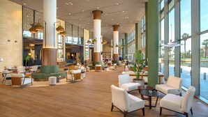 A spacious lobby with high ceilings, large windows, and modern furnishings. - Melia Valencia (Valencia)