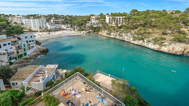 Une ville côtière avec une plage, des bâtiments et une mer bleue et limpide.