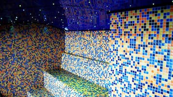 Experience the unique wave-inspired ceiling design and vibrant tile accents in this stylish room.