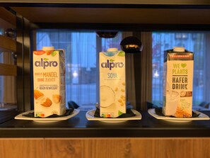 Three cartons of Alpro products on a counter. - Holiday Inn Salzburg City by IHG (Salzburg)