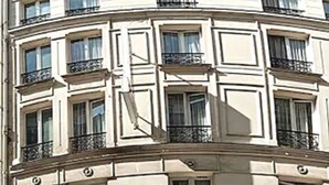 A multi-story building with a classic architectural style, featuring a ground-floor entrance with a sign that reads "HOTEL PARIS-LEGENDRE." - Hôtel Paris Legendre (Paris)