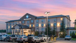 A Best Western hotel with multiple parking spaces, a prominent entrance, and a well-lit facade. - Best Western Rocky Mountain House Inn & Suites (Rocky Mountain House)