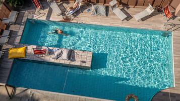 Seasonal outdoor pool, open 10:00 AM to 7:00 PM, sun loungers