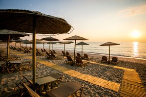 On the beach, sun loungers, beach umbrellas