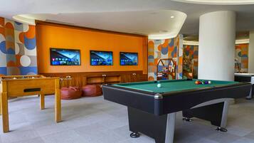 Relax and have fun in this recreational room with a pool table, foosball table, and cozy seating area.