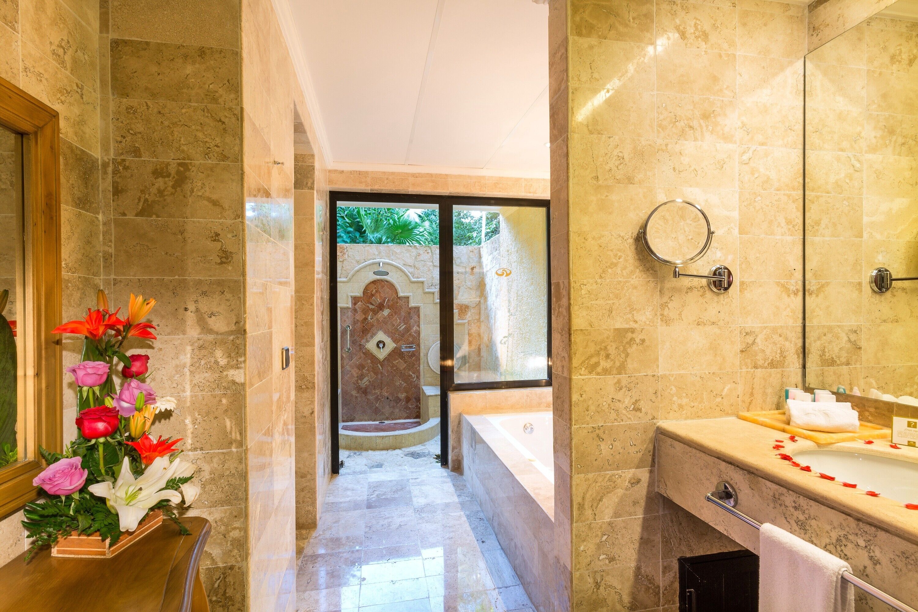 A bathroom with a bathtub, a vanity with a mirror, and a shower area.