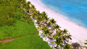 An aerial view of a beach with white sand, palm trees, and a clear blue ocean. - Grand Palladium Select White Sand Resort & Spa - All Inclusive (Kantenah)
