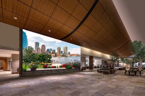 A spacious lobby with a large mural of a city skyline and a waterfront view. - The Westin Boston Seaport District (Boston)