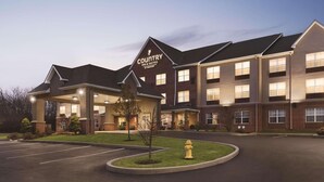 A Country Inn & Suites hotel with a brick facade, multiple windows, and a well-lit entrance. - Country Inn & Suites by Radisson, Beavercreek-Dayton (Dayton)
