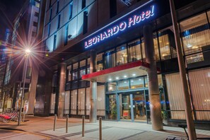 The exterior of the Leonardo Hotel with its illuminated signage, large glass windows, and a visible entrance. - Leonardo Hotel Milton Keynes  (Milton Keynes)