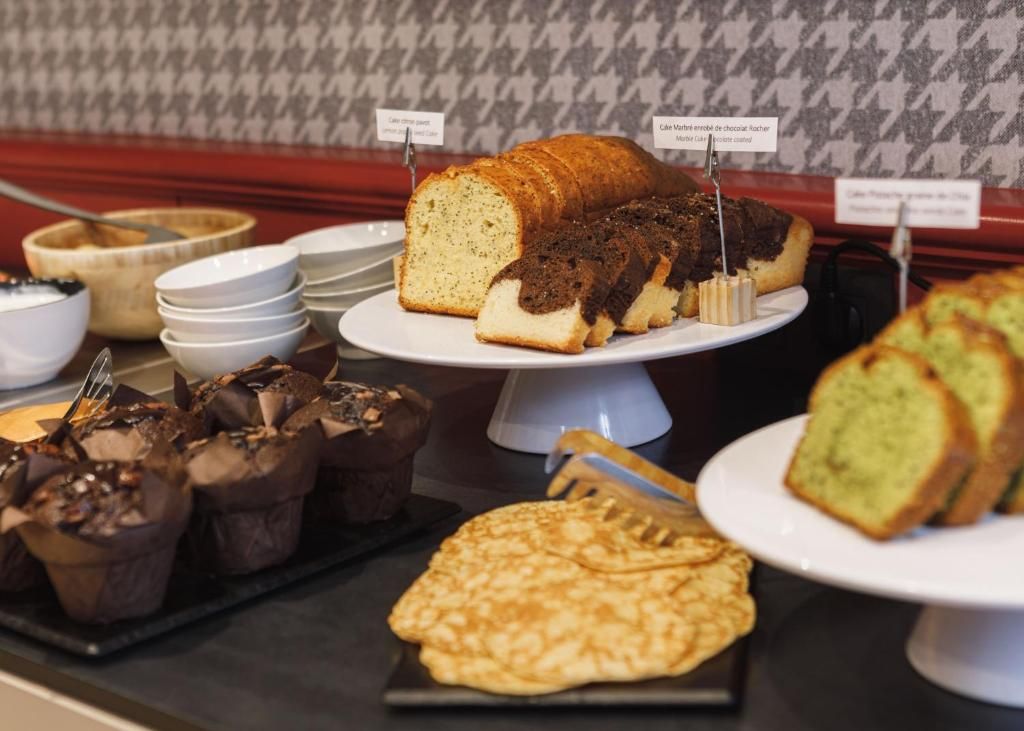A variety of baked goods including a loaf of bread, muffins, and pastries on display.