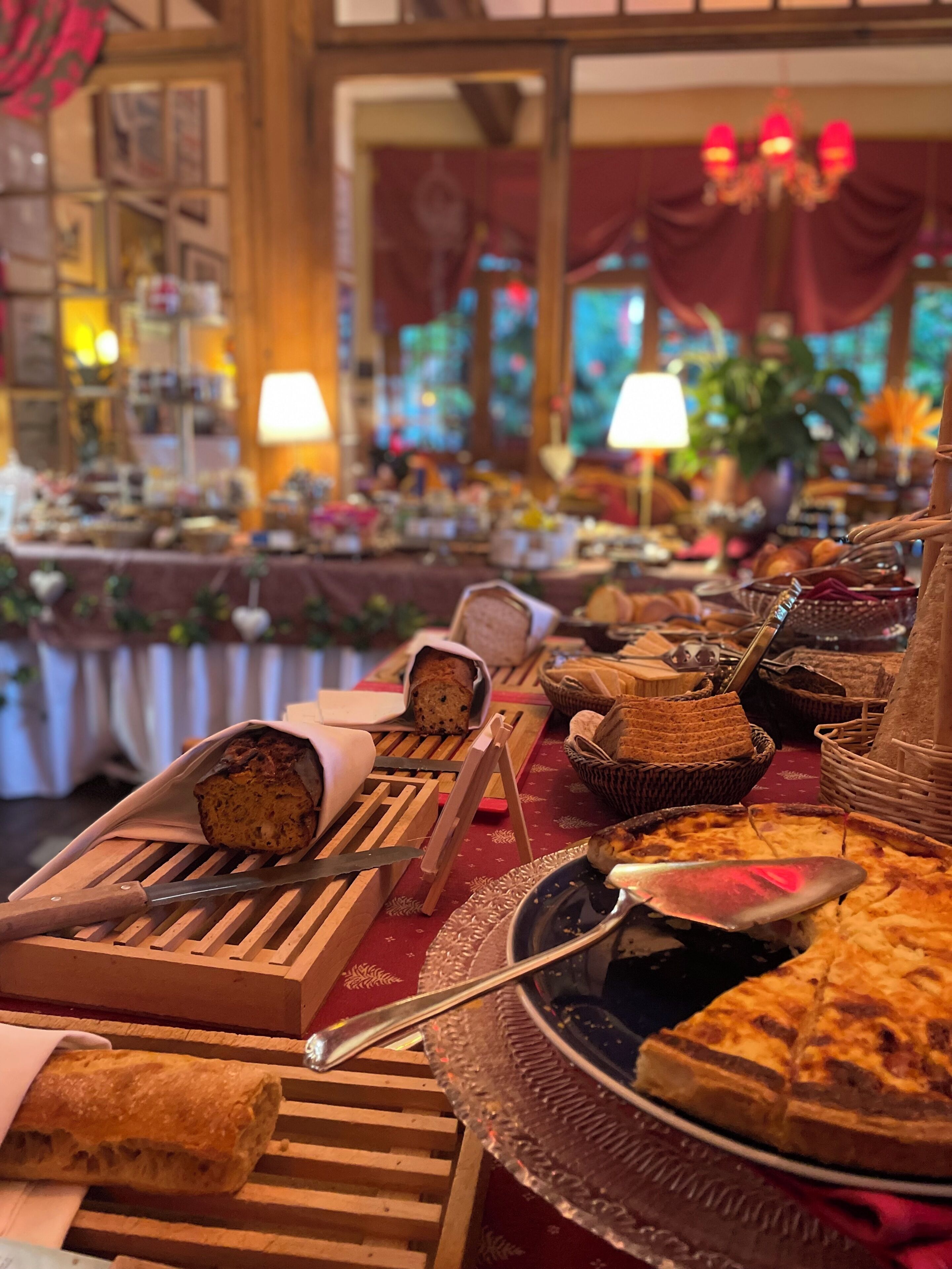 A buffet table with various food items and serving utensils.