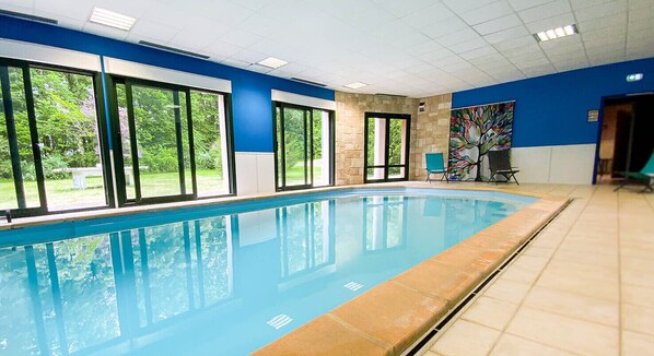 Indoor pool, open 7:00 AM to 7:00 PM, pool loungers