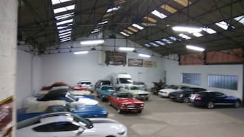 A parking garage with multiple cars parked in rows.