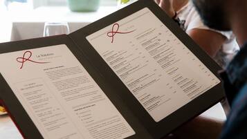 A menu with the restaurant's name and a list of dishes.