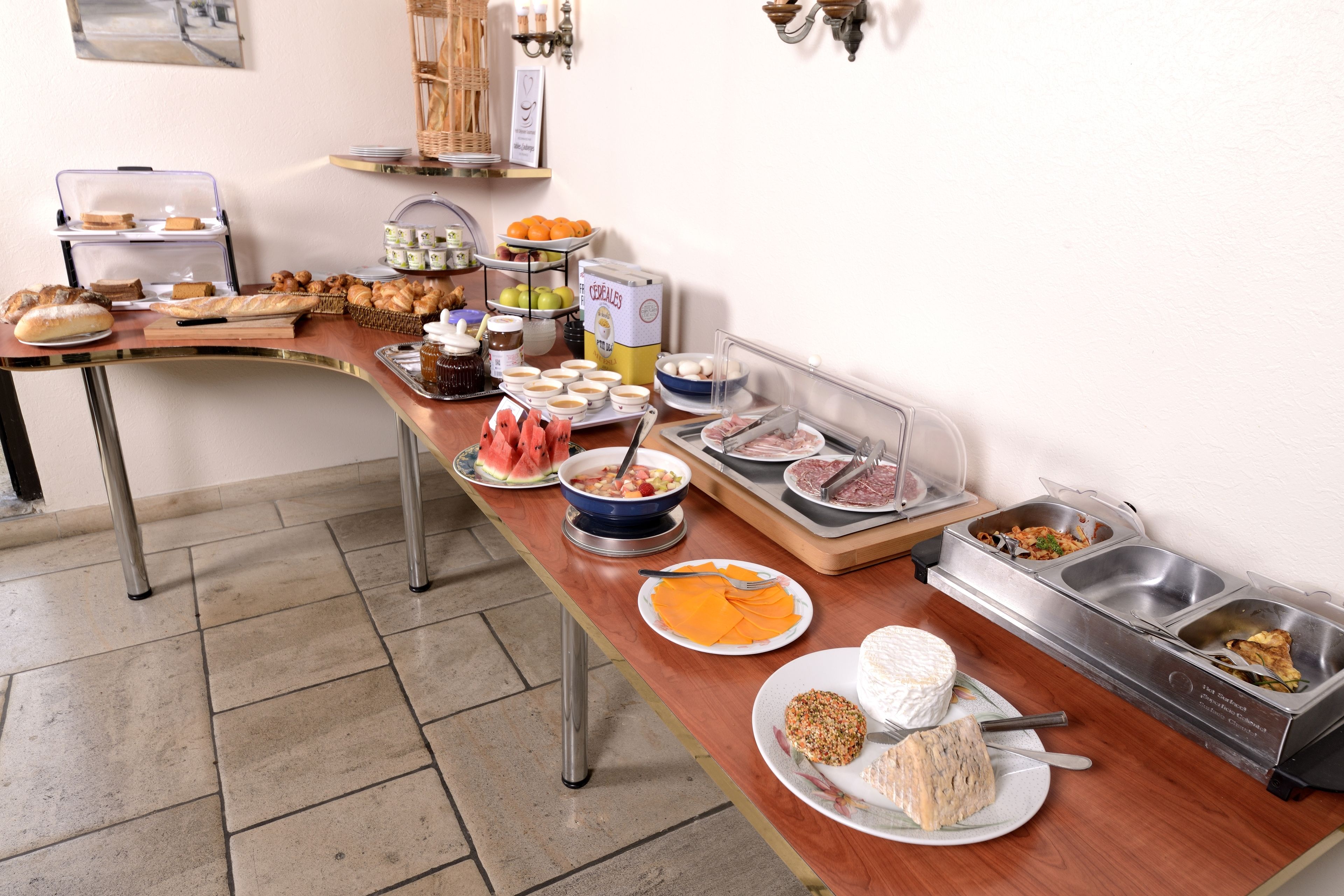 A buffet setup with various food items and containers.
