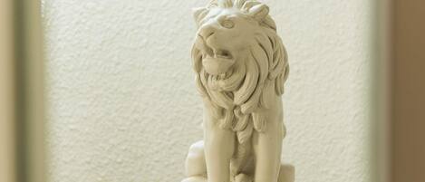 A white lion statue on a pedestal.