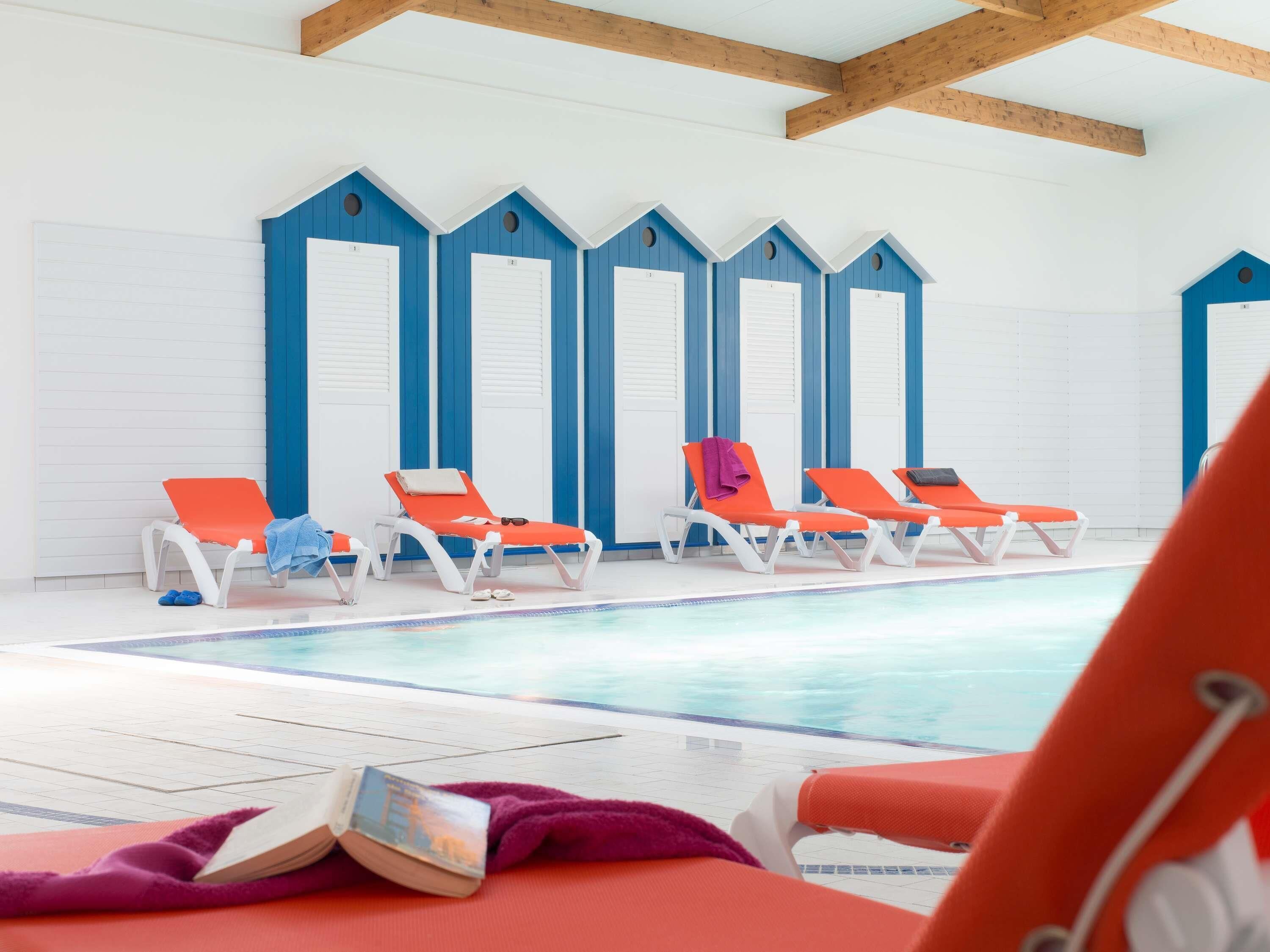 Indoor pool, open 9:00 AM to 9:00 PM, pool loungers