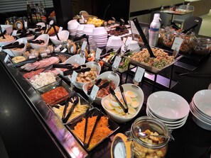 A buffet with various food items including meats, cheeses, and salads. - Campanile Auch (Auch)