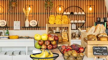 A bakery display with various baked goods and fruits.