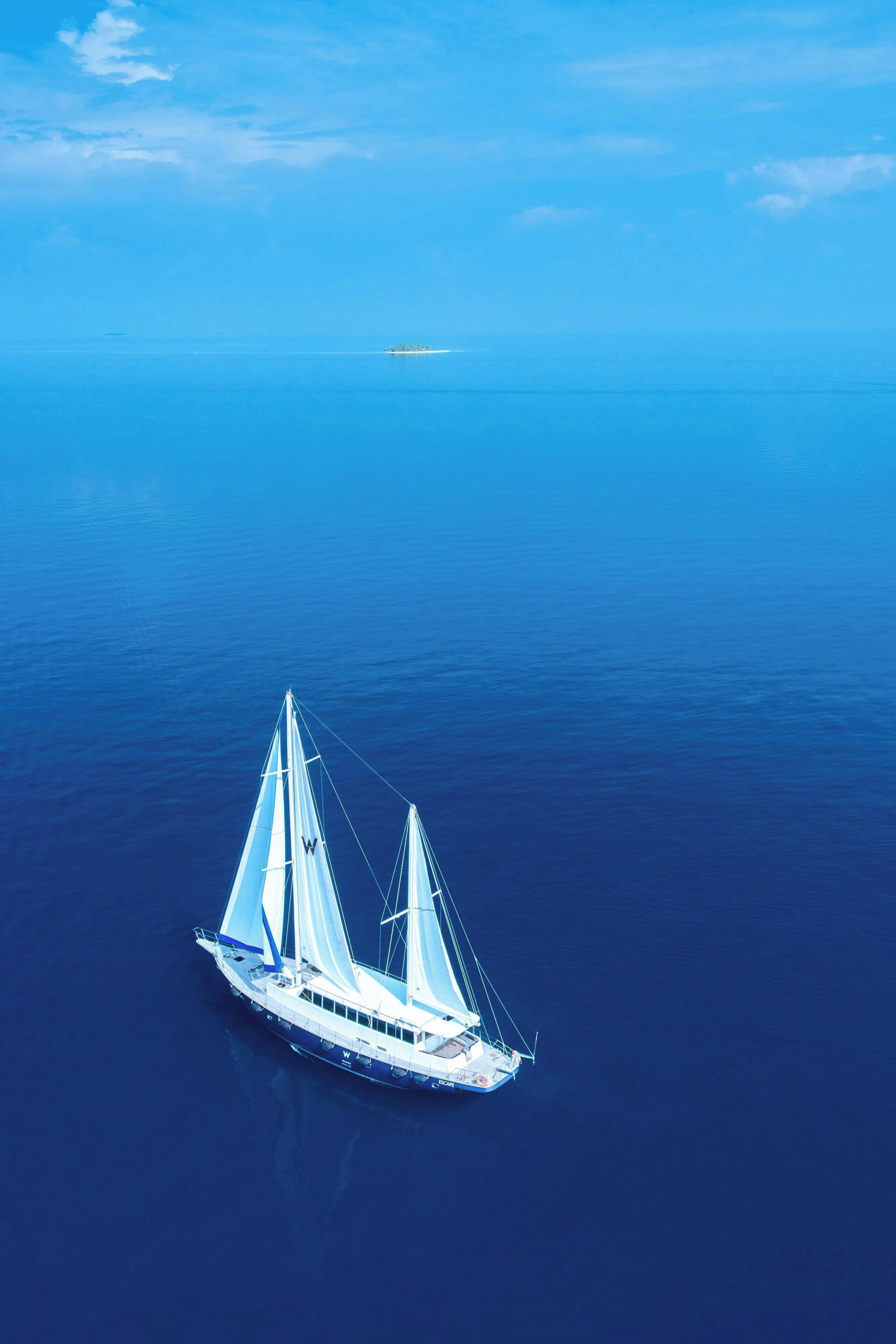 A white yacht sailing on a calm sea.